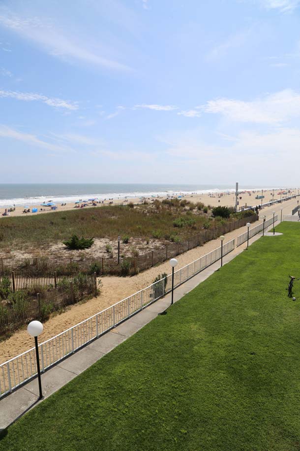 View of ocean, boardwalk and lawn area