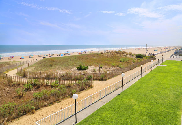 View of ocean, boardwalk and lawn area